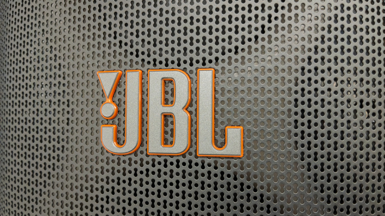 A JBL logo on a speaker grille.