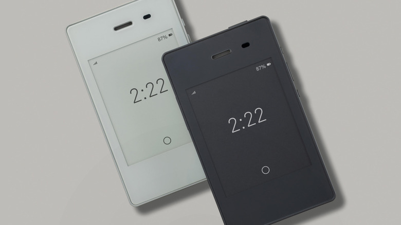 The Light Phone II on a light grey background in two colors.