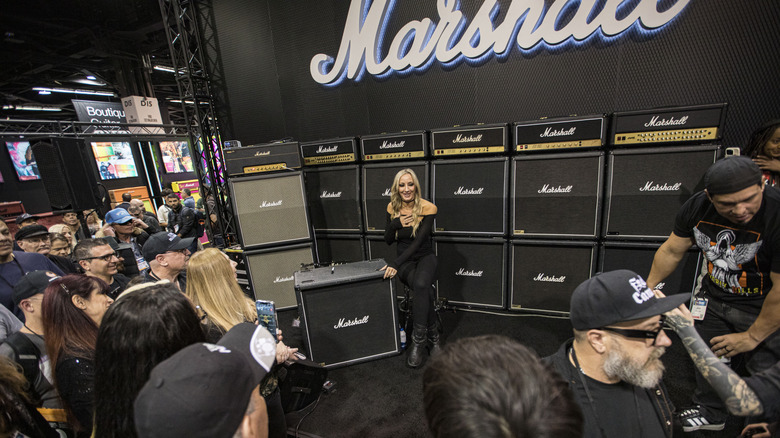 Alice Cooper guitarist Nita Strauss poses with Marshall amplifiers at the 2025 NAMM show in Anaheim, CA