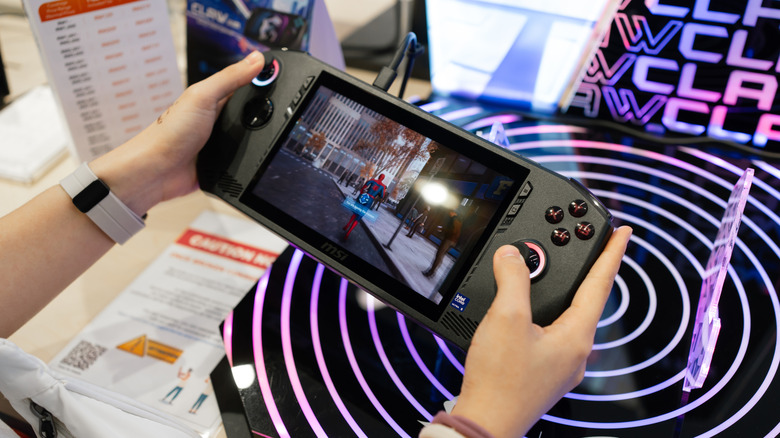 person gaming on msi claw console