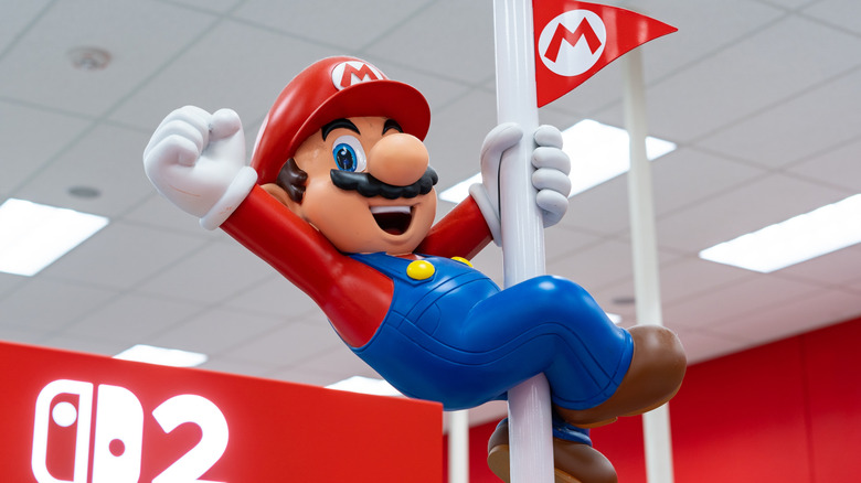 a statue of Mario on a pole near Nintendo Switch 2's for sale