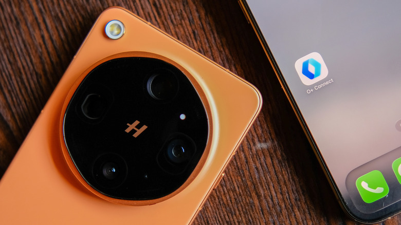 An Oppo Find X9 Ultra in orange with its large rear camera plate.