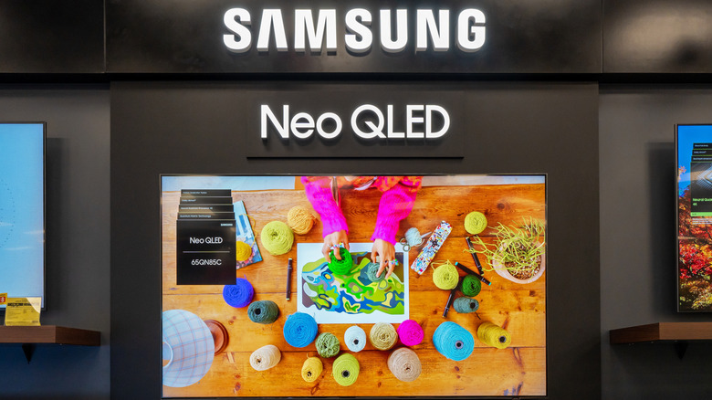 Samsung QLED TVs on display in a store.