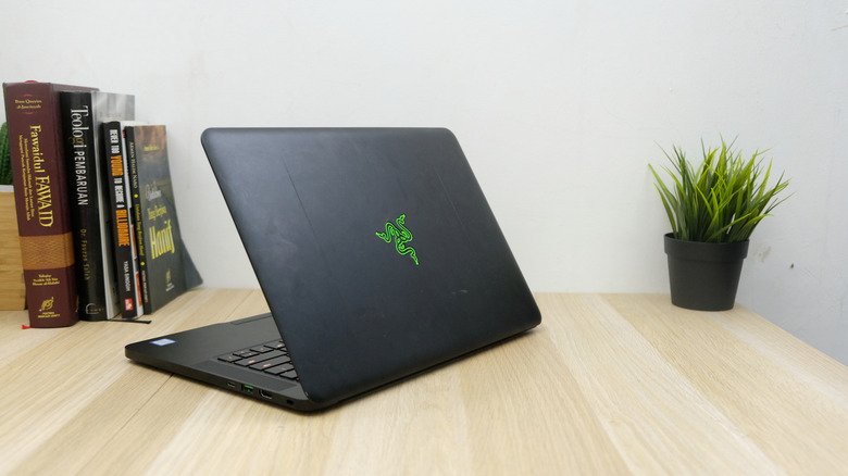 A Razer laptop shown from the rear on a desk