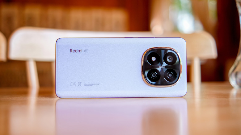 A Redmi Note 14+ Pro perched on its side on a table
