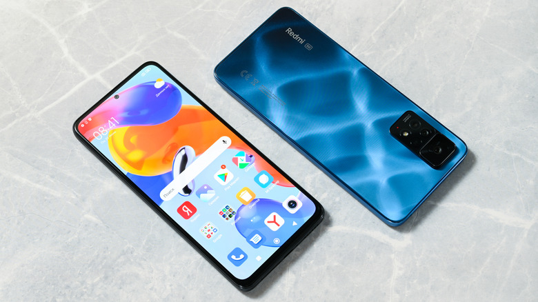 A Redmi Note 11 Pro on a white marble background