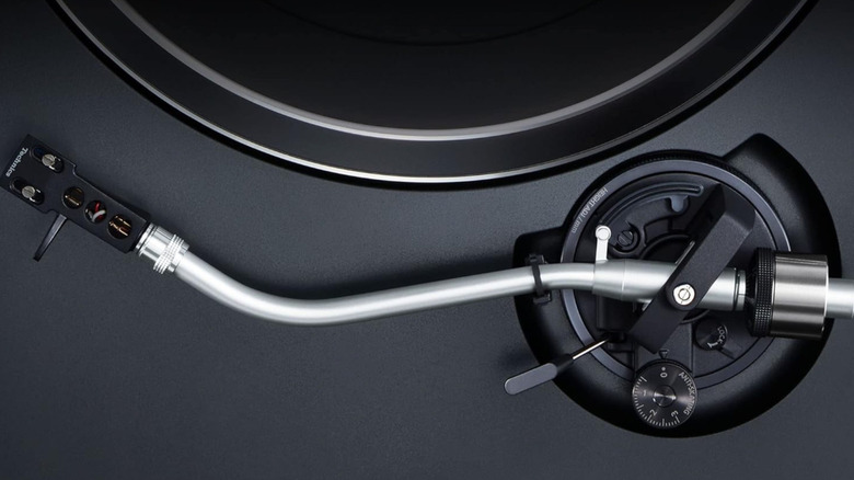 A closeup image of the needle mechanism on a Technics turntable.