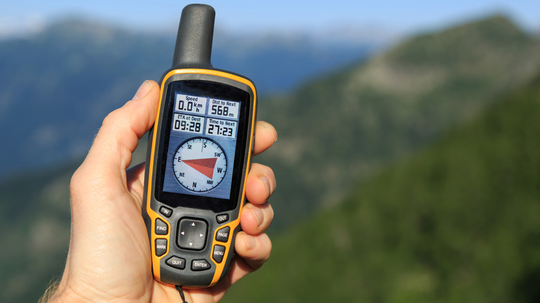 Handheld GPS device with visual compass for checking heading.