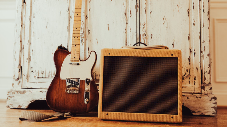 a guitar next to a vintage amp