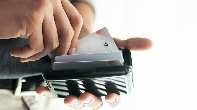 A man pulling a credit card out of his RFID blocking wallet