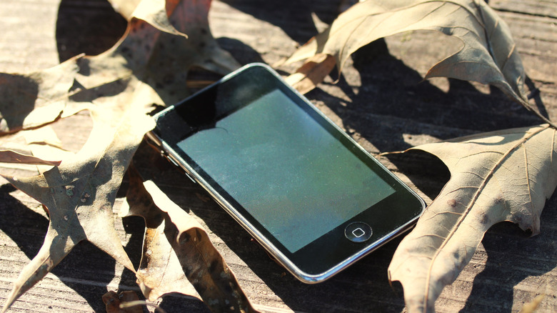 An iPod touch on a wooden table.