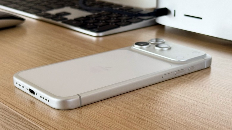 iPhone facing down on a wooden desk