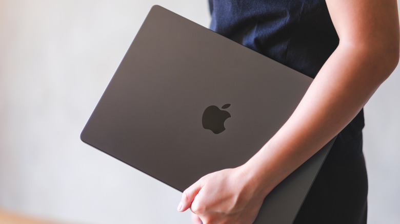 Person carrying a MacBook