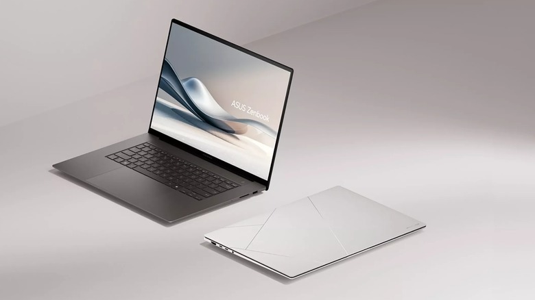 Black and white Asus Zenbook S laptops in front of a white background