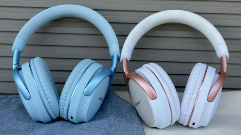 Two pairs of Bose headphones placed next to each other. One is light blue, the other white with rose gold accents.