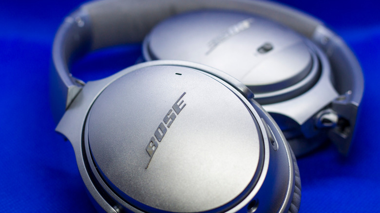A pair of Bose headphones set against a dark blue backdrop.