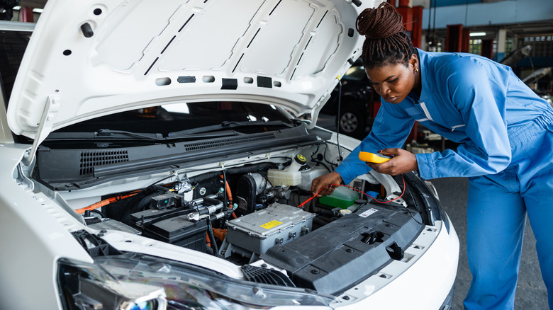 Image of a mechanic working on an EV