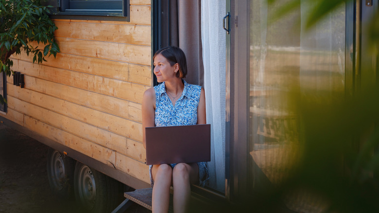 A woman outside with a laptop