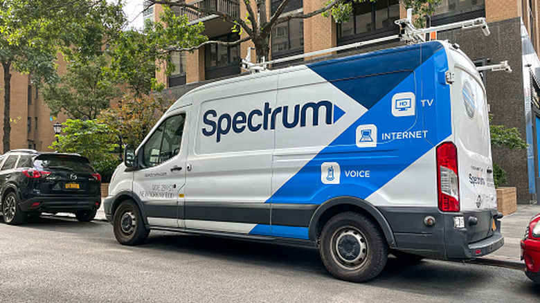 Spectrum service van parked in a residential neighborhood.