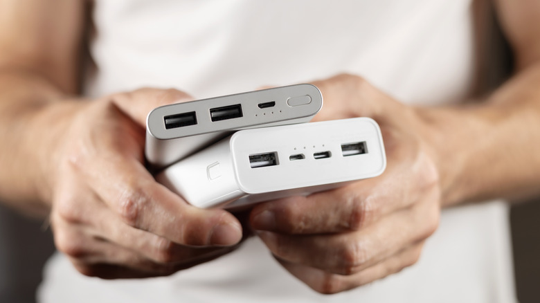 person holding two power banks
