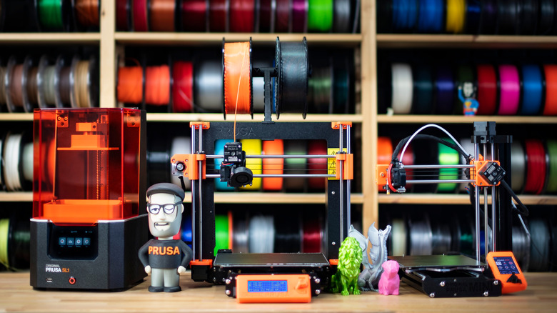 Original Prusa 3D printers with filament in the background.