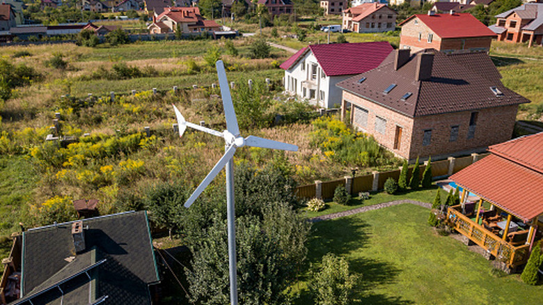 A home with a wind turbine.