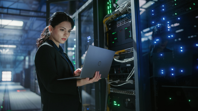 An engineer examining server infrastructure at a data center