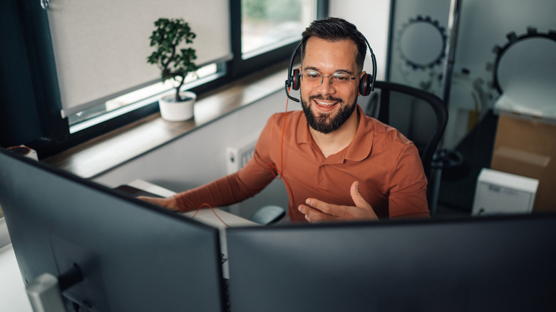 A remote worker using two differently-sized monitors