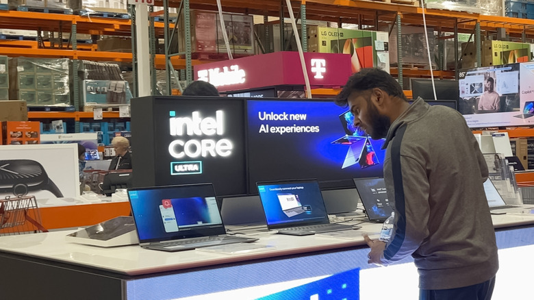 A person looking at Intel laptops in Costco