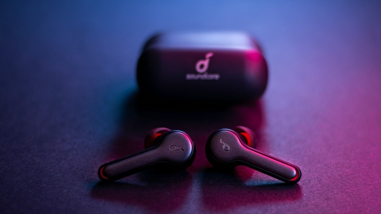 Anker Soundcore Air 2 bluetooth earbuds in foreground with case and logo behind.