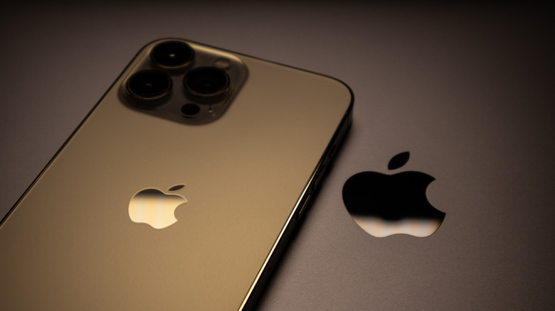 Apple logos seen on the back of an iPhone and a MacBook.