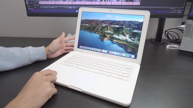 A person using a white MacBook in 2024.