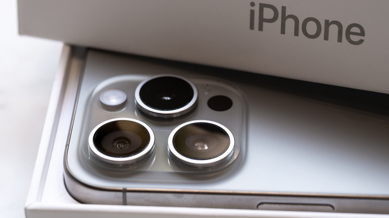The iPhone 15 Pro in its retail box, with the titanium frame in view.