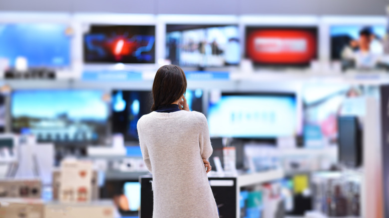person shopping in the TV aisle