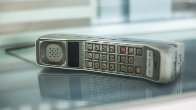 A Motorola DynaTAC 8000X on a glass surface.