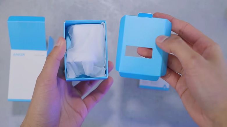 Mrwhosetheboss holding the box of an Anker phone charger