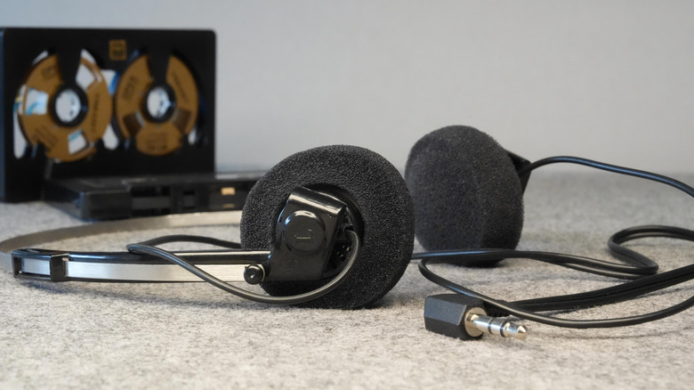 Close up of vintage wired headphones on a countertop.