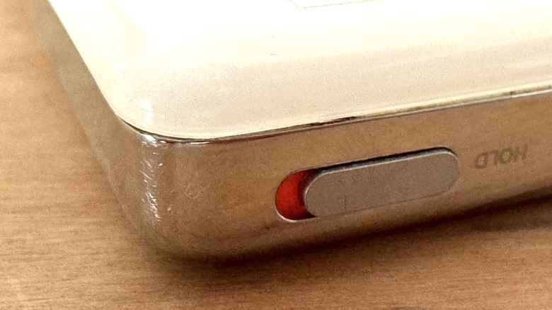 The Hold switch sliding button on an Apple iPod.