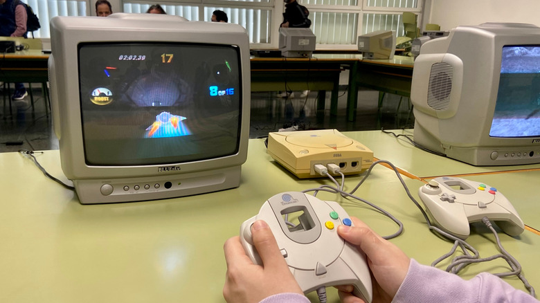 Someone playing a Sega Dreamcast on an old CRT TV at an event