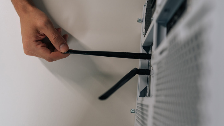 Close-up overhead view of a person installing Wi-Fi antennas into a desktop computer