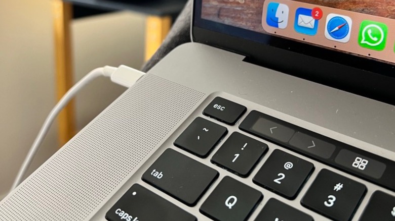 Close-up shot of MacBook Pro with Touch Bar charging