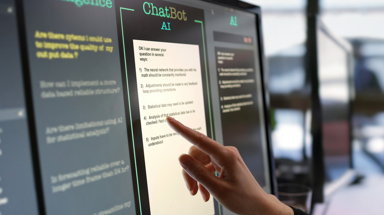 A woman touching a computer screen
