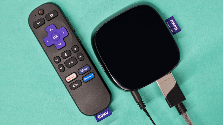 Two Roku devices on a green surface