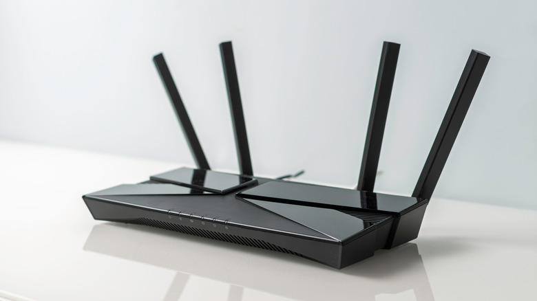 Sleek Wi-Fi router with external antennas visible on the rear.