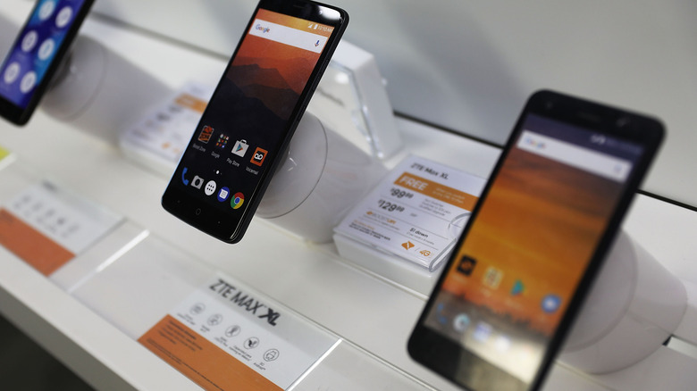 Two ZTE Android phones on a retail store shelf.