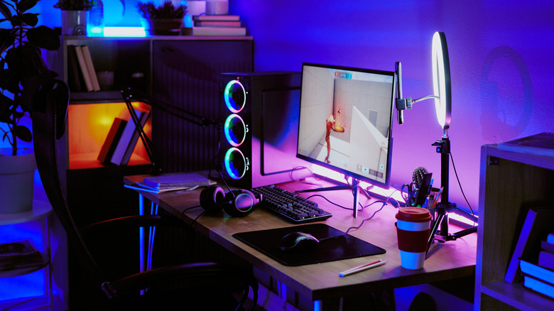 A modern gaming desktop setup with a white lamp