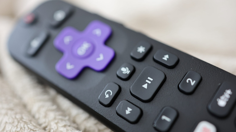 Close up of a Roku remote control on a blanket