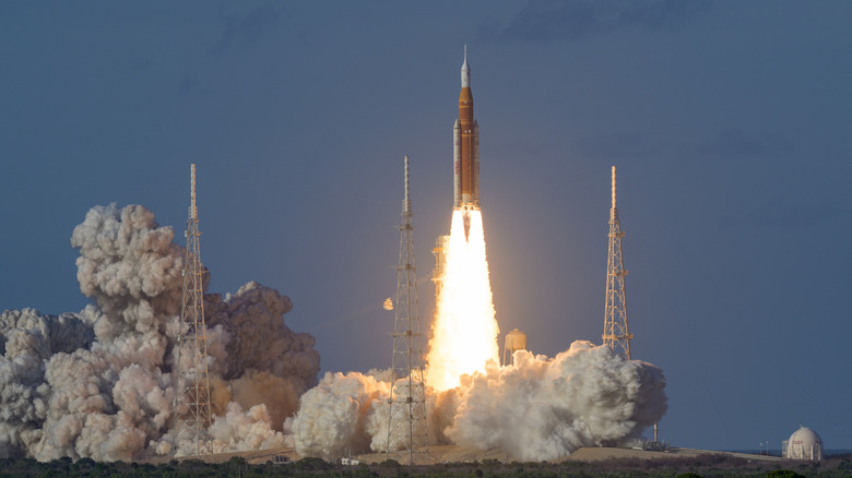 NASA's Artemis II mission in launch, fire and smoke billowing from its rockets