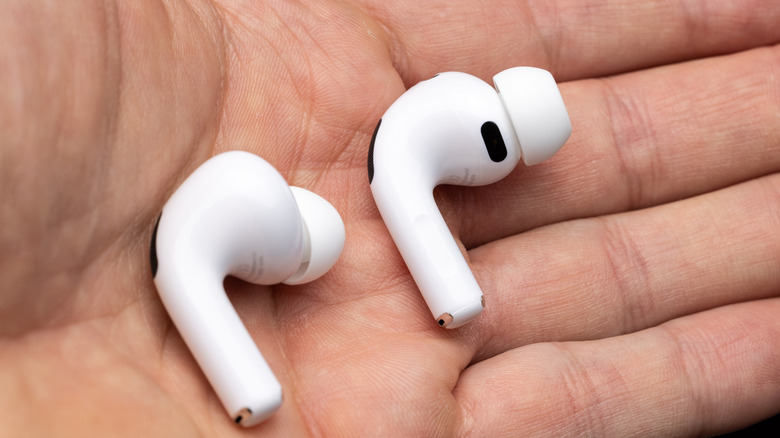 AirPods in the palm of someone's hands
