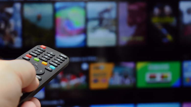 Person using remote on smart TV